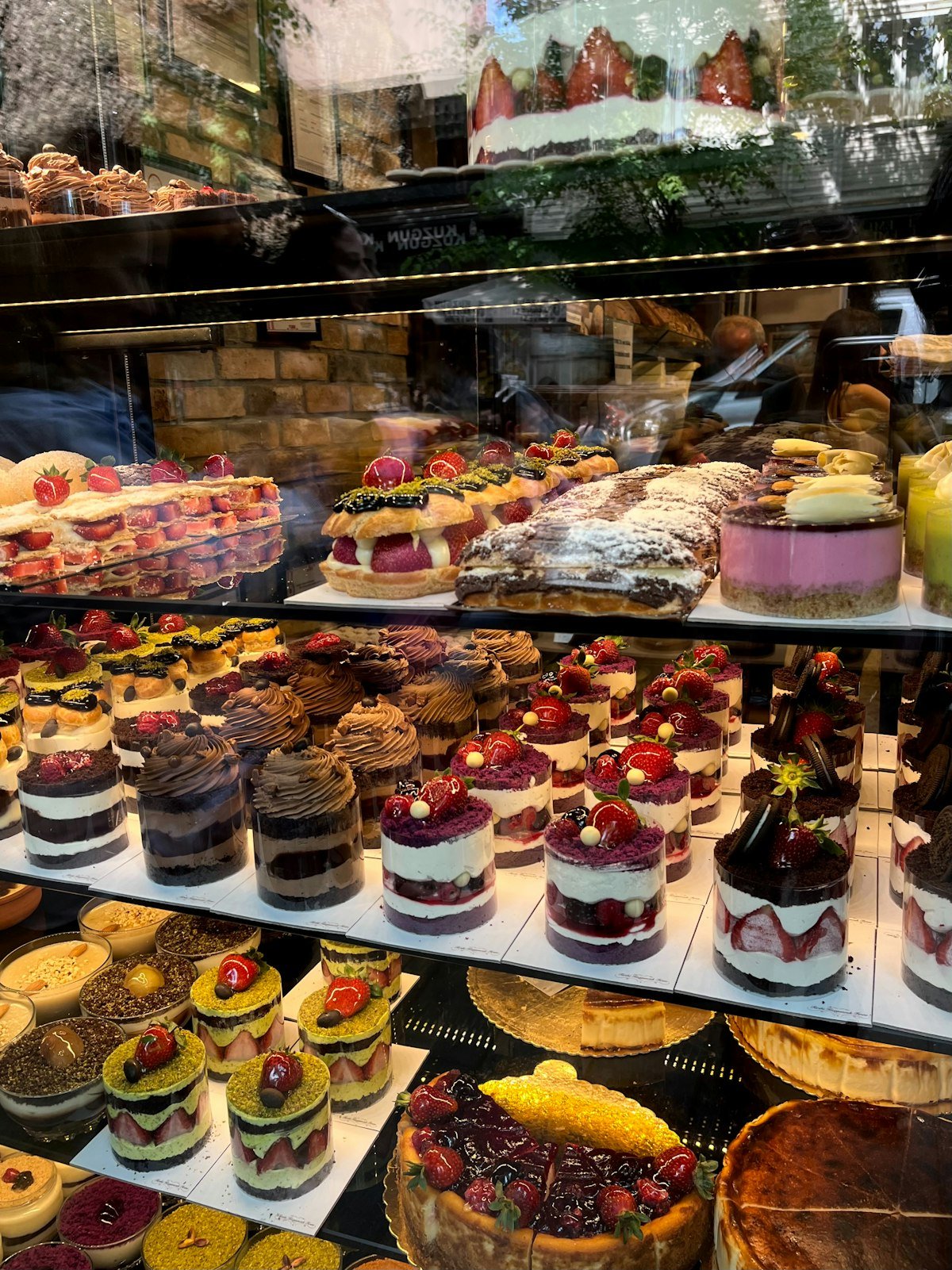 Cakes lined up in the refrigerated case