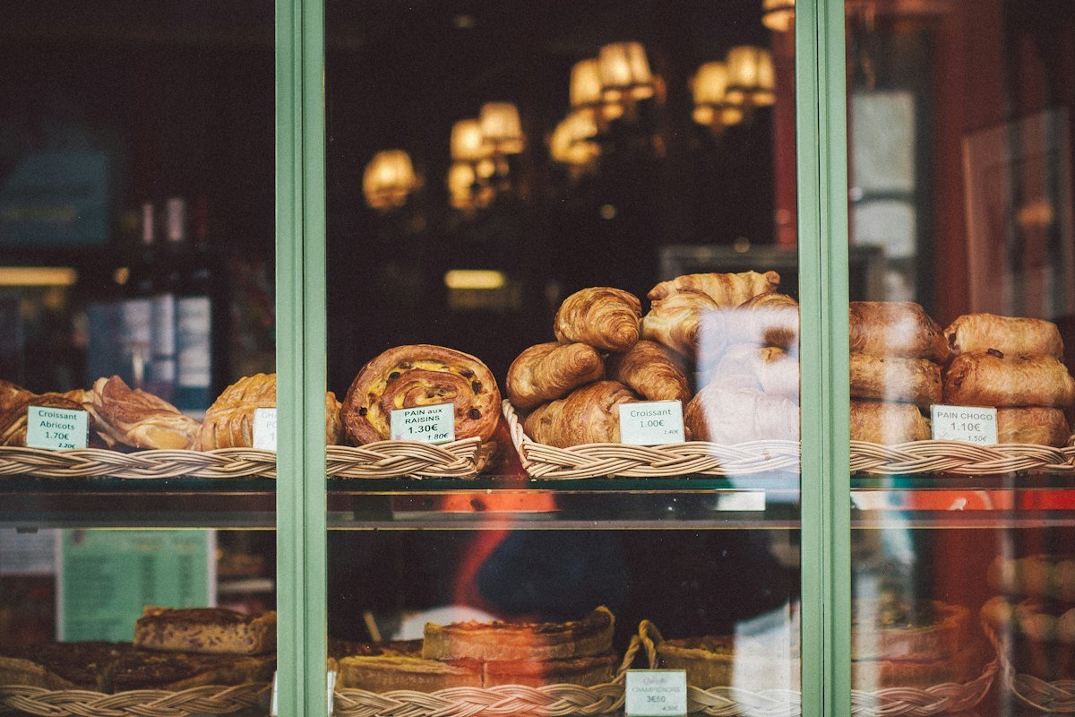 The shop seen through the front window from the sidewalk