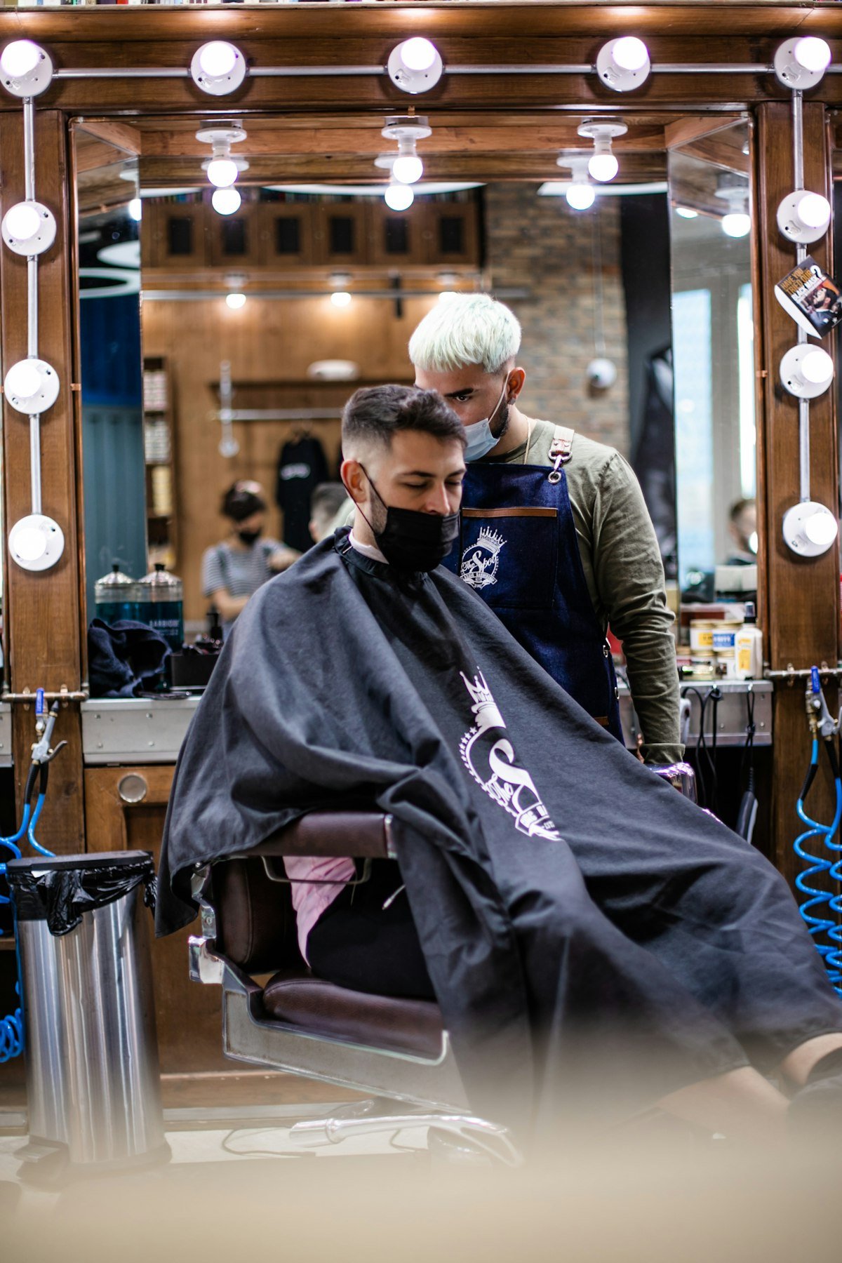 Barber working on a client in the chair at the shop
