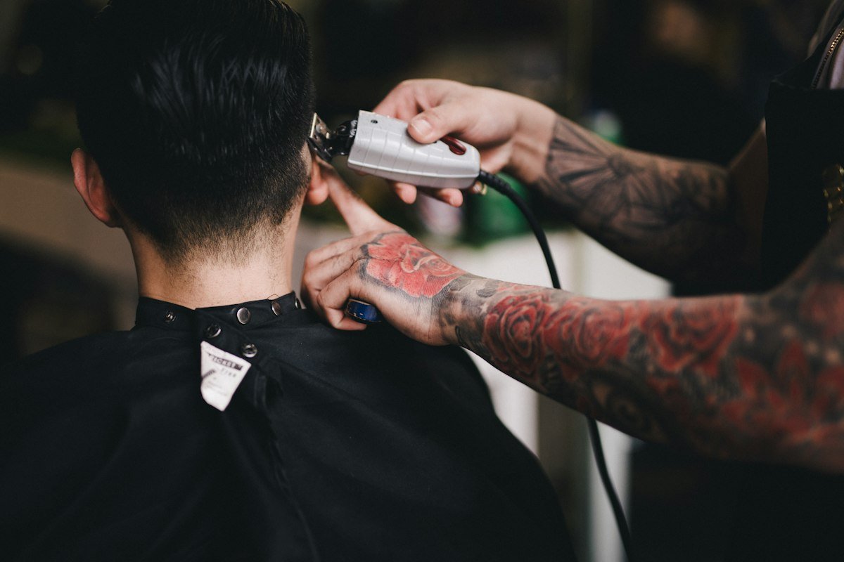 Barber cleaning up a neckline with a clipper