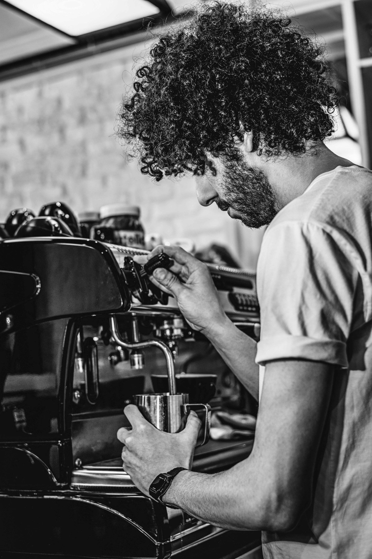 Roaster working the espresso machine inside the shop