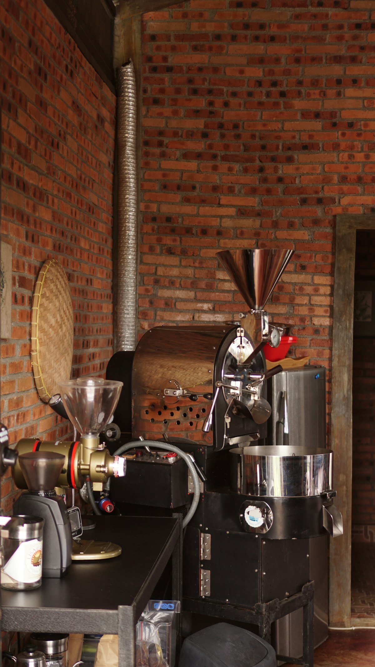 The roaster machine against the brick wall of the shop