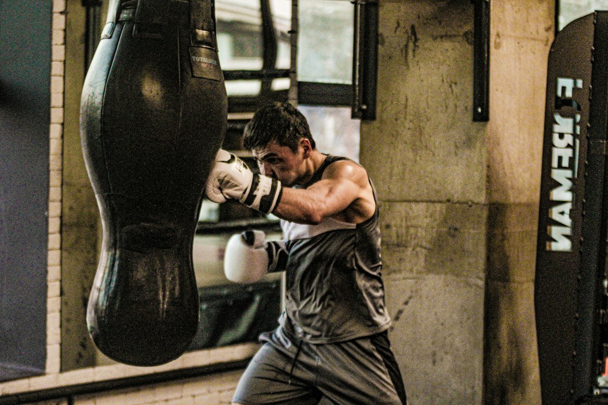 Boxer working the heavy bag in the gym