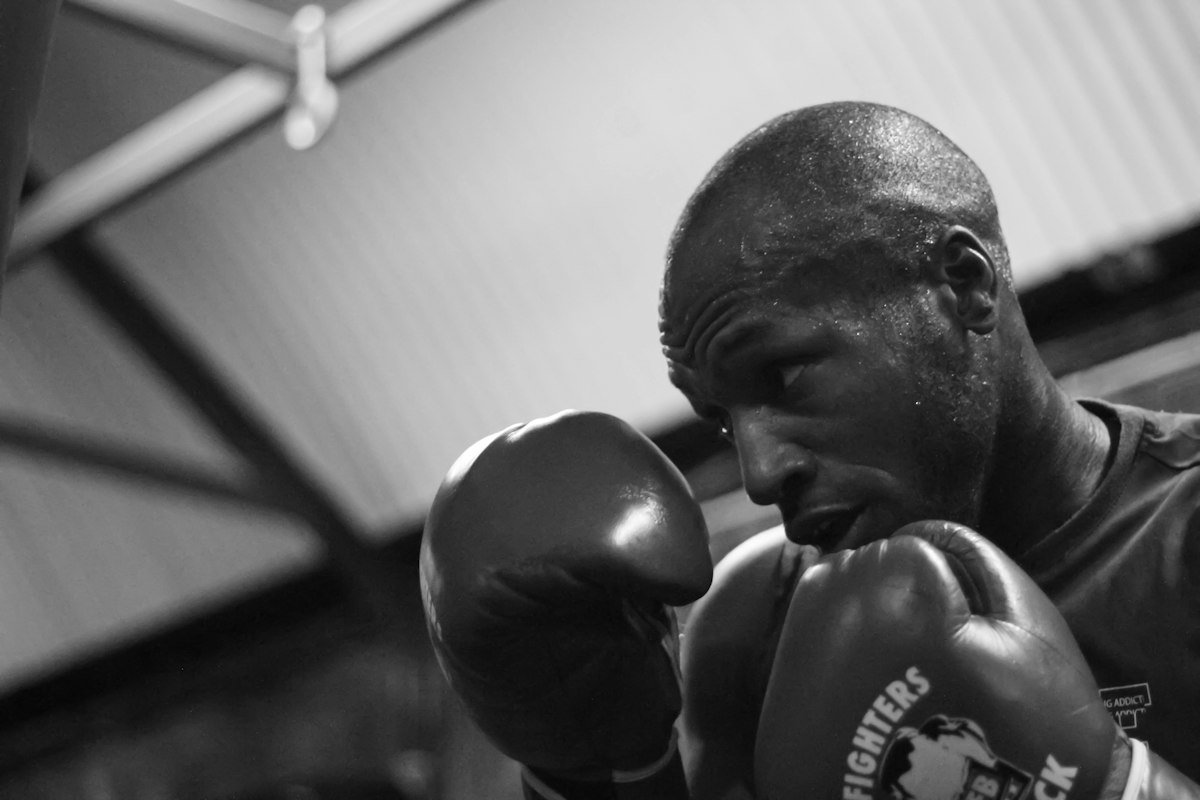 Coach with gloves up in the gym