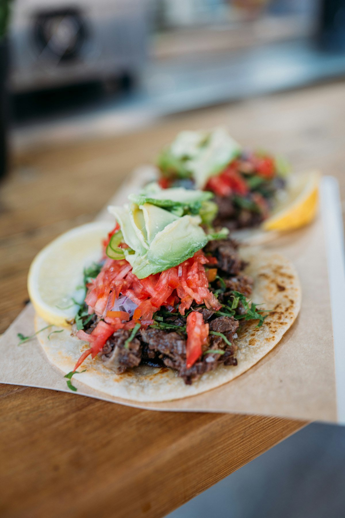 Close view of a loaded taco on a dark table